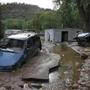 Cars lay mired in mud deposited by floods in Lyons, Colo. on Friday.